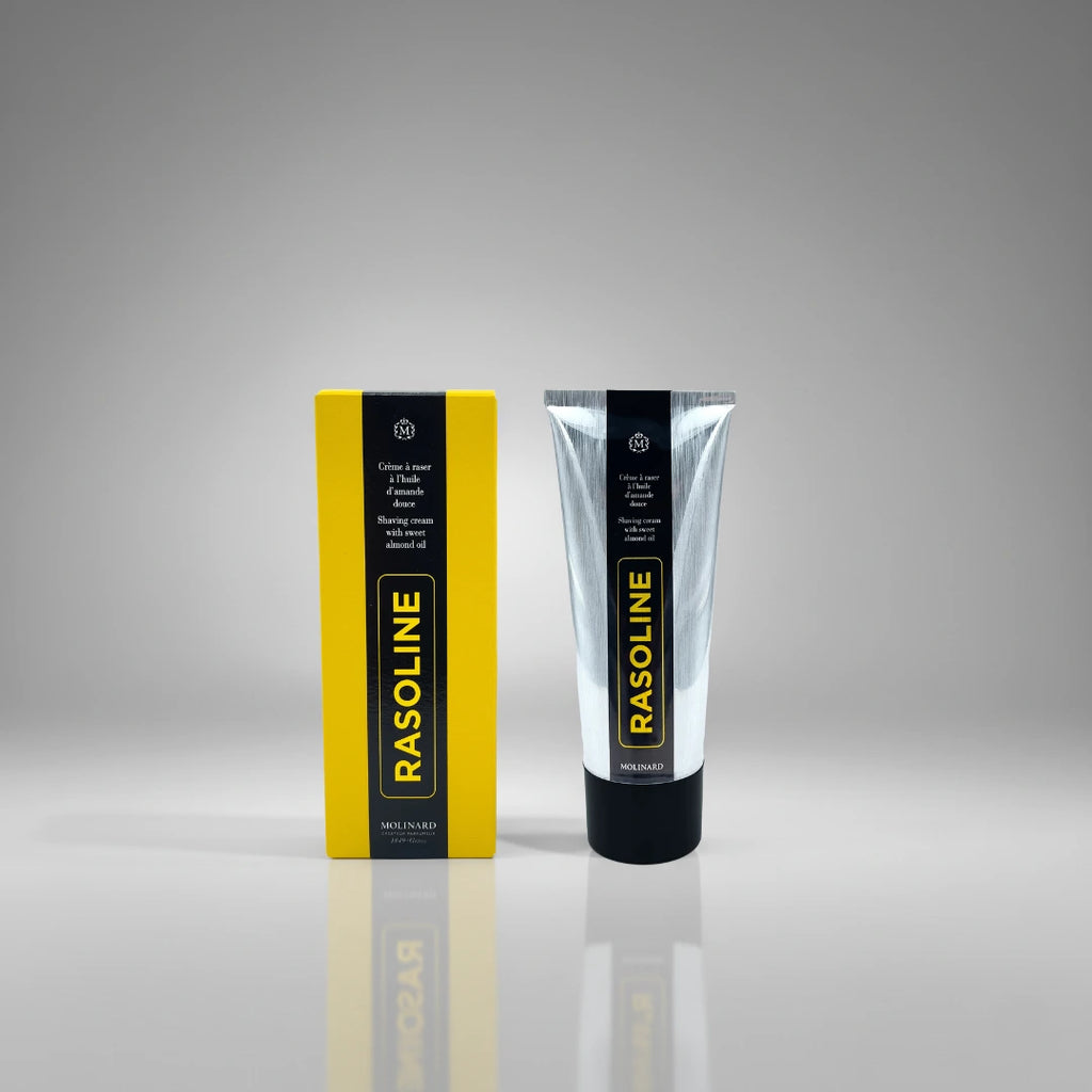 Crème à raser Rasoline Molinard présentée avec sa boite jaune emblématique, une formule historique à l'amande douce pour le soin des hommes.