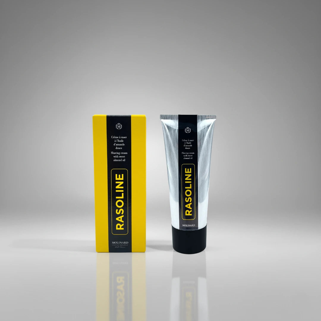 Crème à raser Rasoline Molinard présentée avec sa boite jaune emblématique, une formule historique à l'amande douce pour le soin des hommes.
