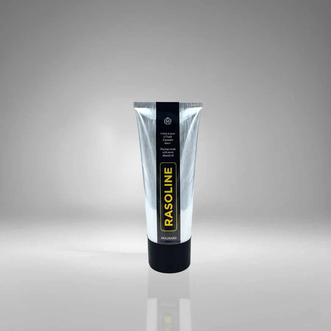 Tube de crème à raser Rasoline de Molinard, soin traditionnel à l'huile d'amande douce pour un rasage confortable et protégé.