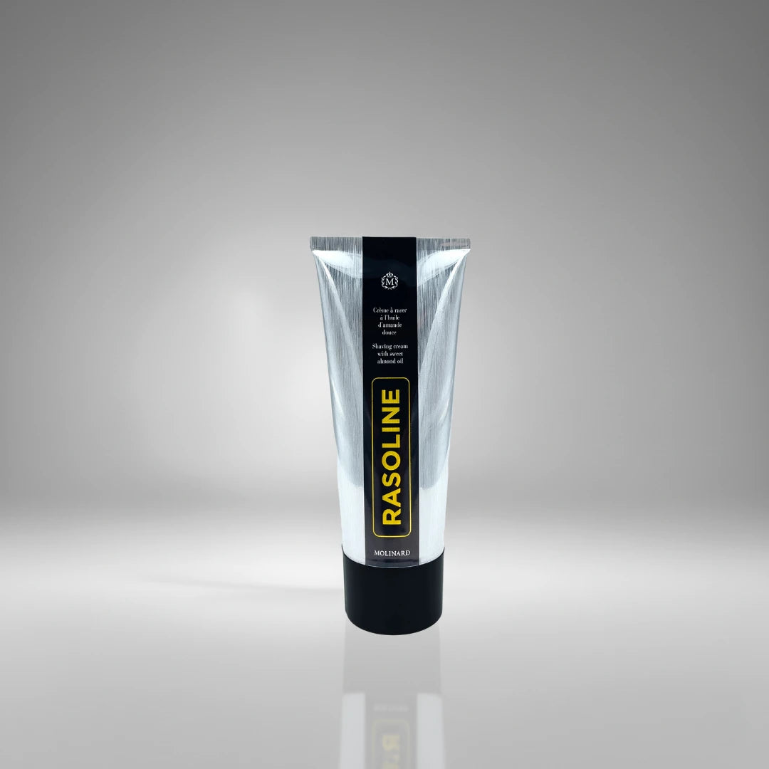Tube de crème à raser Rasoline de Molinard, soin traditionnel à l'huile d'amande douce pour un rasage confortable et protégé.